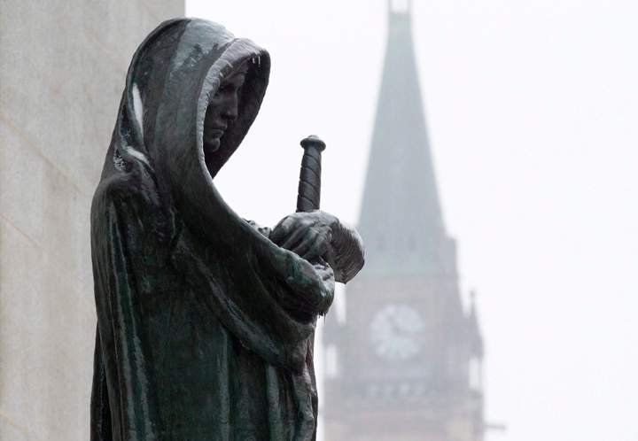 A statue representing Justice is seen in front of the Supreme Court building in Ottawa. 
