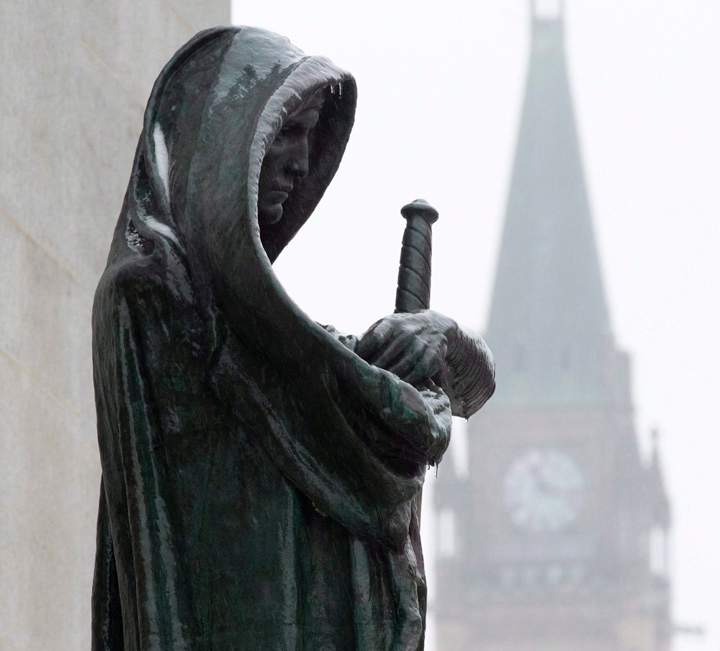 A statue representing Justice is seen in front of the Supreme Court building in Ottawa. 
