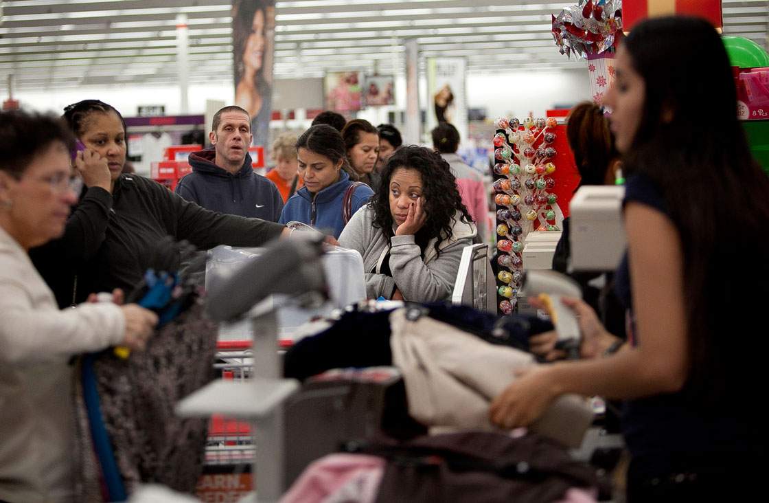 Tired shoppers head for the checkout at Kmart Black Friday sale in Massachusetts. (Getty Images)