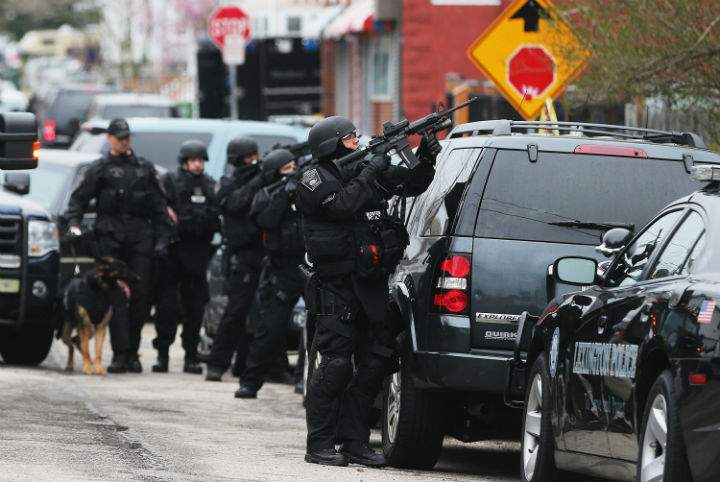 A SWAT team stands on guard as police search of Dzokhar Tsarnaev in Watertown, Mass.