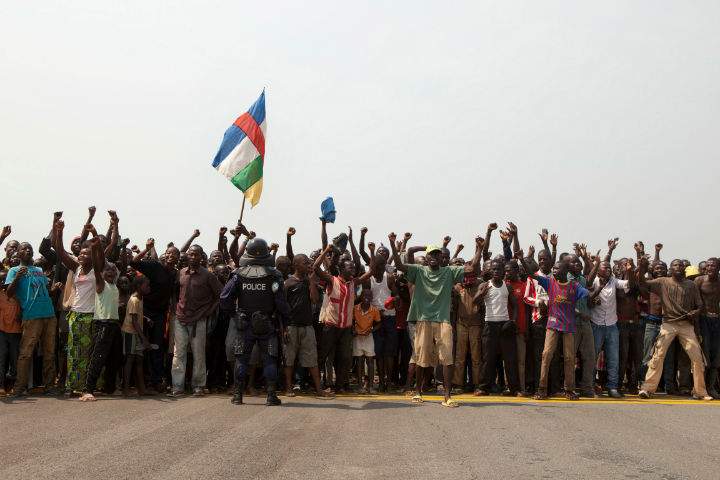 A thousand people living in a makeshift camp for the displaced at Mpoko Airport create a barrier across the runway, shouting for president Michel Djotodia to step down, in Bangui, Central African Republic