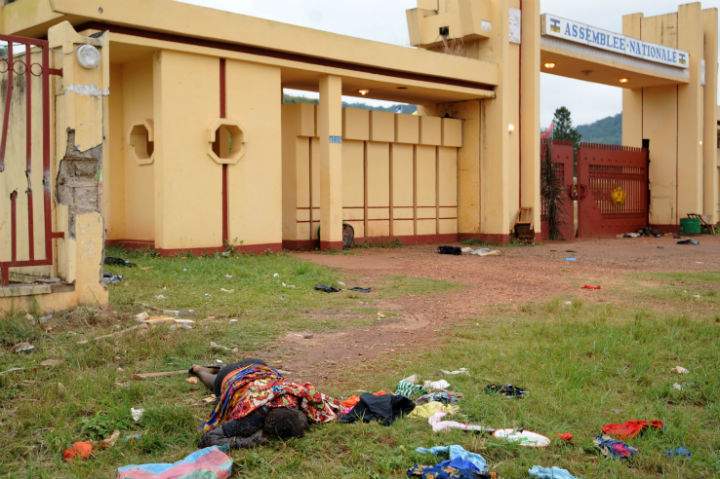 The body of a man killed during recent clashes in front of the National Assembly building in Bangui remains outside the assembly building, on December 6, 2013. French troops have killed several armed fighters in the Central African Republic as Paris on December 6 rolled out a UN-backed operation to restore security after a bloodbath that left scores of bodies strewn across the capital. (Photo by Sia Kambou/AFP/Getty Images)