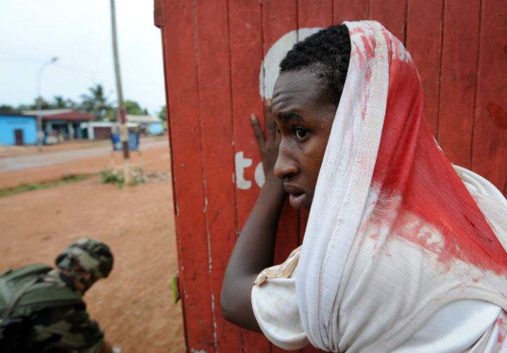 A wounded man waits for assistance during a disarmament operation by French soldiers in Bangui, on December 9, 2013. French troops on Monday began disarming fighters in the Central African Republic after a swell in sectarian violence that has claimed hundreds of lives and terrified inhabitants. (Photo by: Sia Kambou/AFP/Getty Images)
