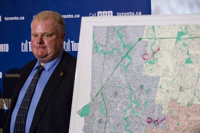 Toronto Mayor Rob Ford stands next to a map of the city at a news conference after an ice storm left over 250,000 customers across the city without power on Sunday, December 22, 2013.