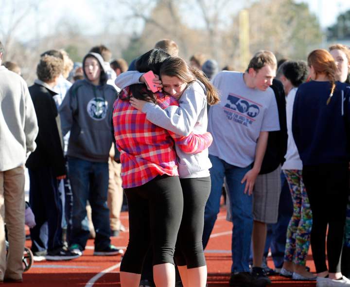 Students comfort each other at Arapahoe High School in Centennial, Colo., on Friday, Dec. 13, 2013, where a student shot at least one other student at a Colorado high school Friday before he apparently killed himself, authorities said. AP Photo/Ed Andrieski)
