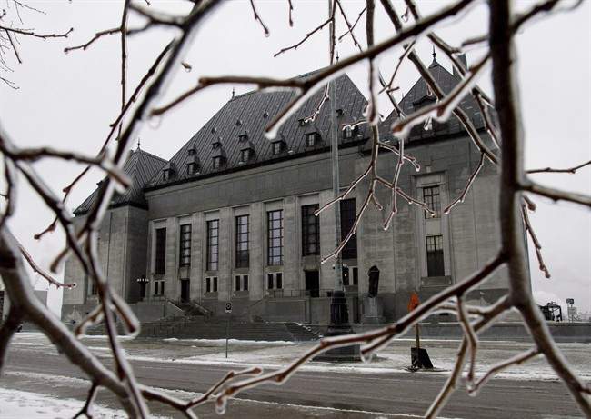 Ice coats tree branches outside of the Supreme Court of Canada in Ottawa on December 10, 2012. 