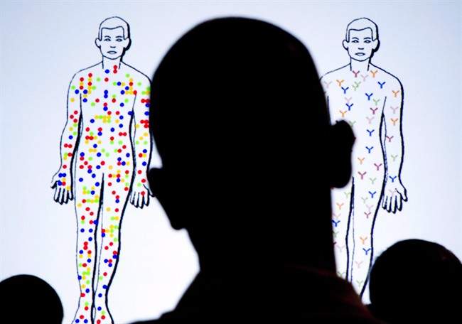 Members of the audience look at slides projected on video screens during the XIX International AIDS Conference, in Washington, July 25, 2012.