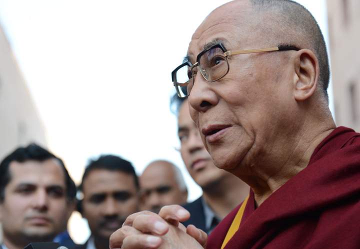 Tibetan spiritual leader The Dalai Lama speaks to members of the press about the passing of former South African president Nelson Mandela, as he attends a function in New Delhi on December 6, 2013. 