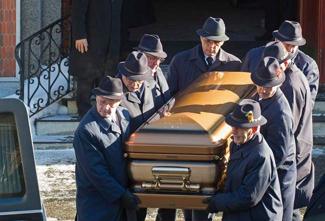 Pallbearers carry the coffin of reputed mafia boss Vito Rizzuto from a church in Montreal, Monday, Dec. 30, 2013, following his funeral.