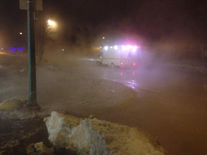 Water floods Jefferson Avenue following a water main break.