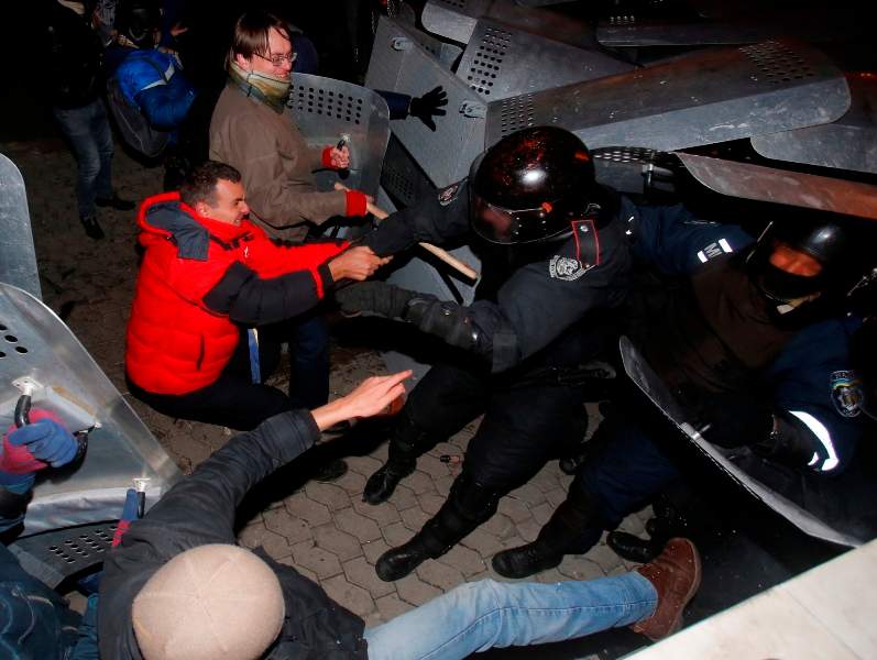 Protesters clash with police guarding the presidential administration building in downtown Kiev, Ukraine, on Sunday, Dec. 1, 2013.