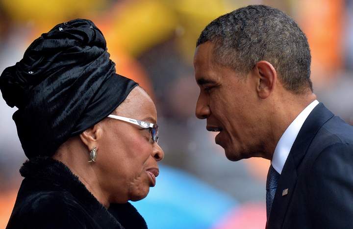 U.S. President Barack Obama (R) talks with the widow of Nelson Mandela, Graca Machel, during the memorial service for late South African President at Soccer City Stadium in Johannesburg on Dec. 10, 2013. (Photo credit: Getty Images)