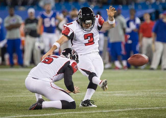 Atlanta Falcons kicker Matt Bryant kicks the game winning field goal with Matt Bosher, left, to defeat the Buffalo Bills in overtime of NFL action in Toronto, Sunday December 1, 2013. THE CANADIAN PRESS/Mark Blinch