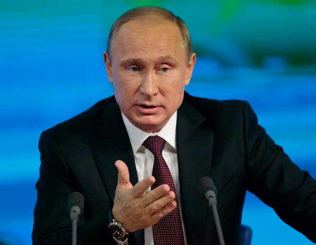 Russian President Vladimir Putin speaks at his annual news conference in Moscow, Russia, Thursday, Dec. 19, 2013. 