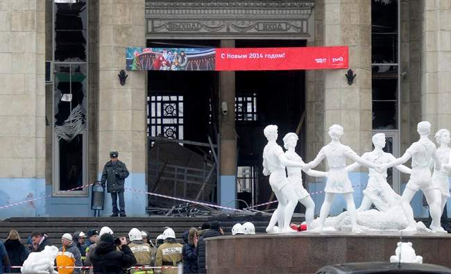 A police officer guards a main entrance to the Volgograd railway station hit by an explosion, in Volgograd, Russia, Sunday, Dec. 29, 2013.
