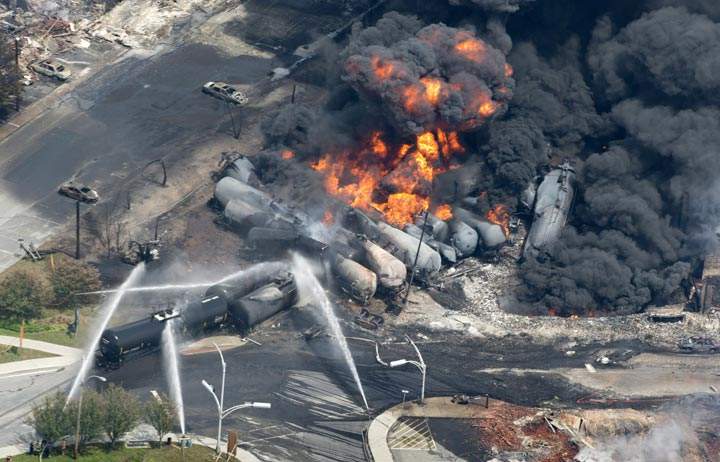 Smoke rises from railway cars that were carrying crude oil after derailing in downtown Lac Megantic, Que. (The Canadian Press /Paul Chiasson)