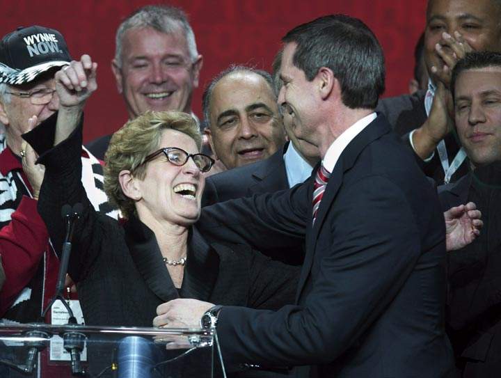 Ontario Premier Kathleen Wynne is congratulated by outgoing Premier Dalton McGuinty after winning the leadership race at the Ontario Liberal Party leadership convention in Toronto. (The Canadian Press /Frank Gunn)