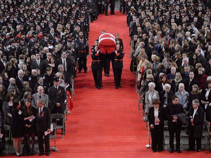 Pallbearers carry the casket of Const. Jennifer Kovach at her funeral in Guelph, Ont. Kovach, 26, died after her cruiser collided with a Guelph Transit bus. (The Canadian Press /Nathan Denette)