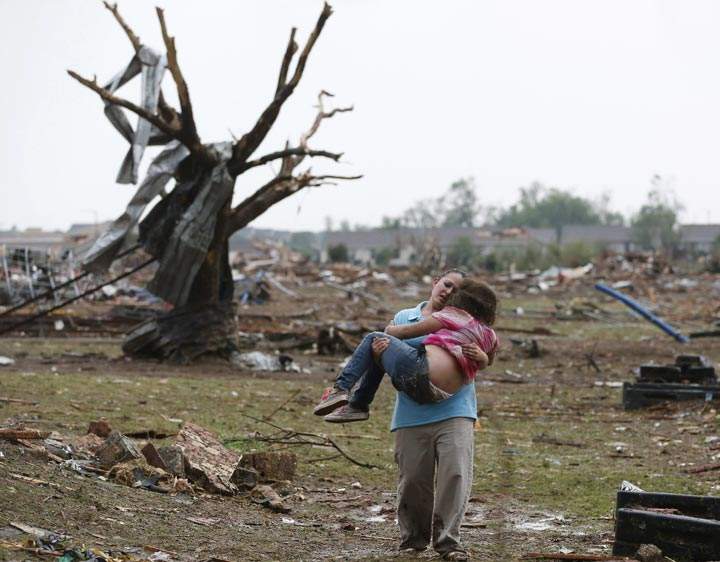 Latisha Garcia carries her 8-year-old daughter, Jazmin Rodriguez, near Plaza Towers Elementary School after a massive tornado carved its way through Moore, Okla. (AP Photo Sue Ogrocki)