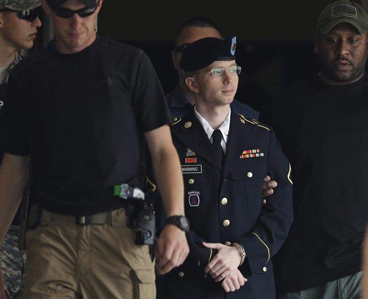 Army Pfc. Bradley Manning is escorted out of a courthouse in Fort Meade, Md. after receiving a verdict in his court martial. Manning was acquitted of aiding the enemy — the most serious charge he faced — but was convicted of espionage, theft and other charges, more than three years after he revealed secrets to WikiLeaks. (AP Photo/Patrick Semansky)