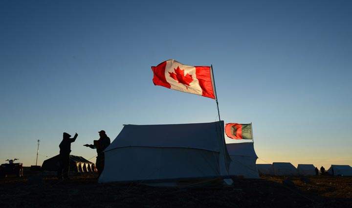 Canadian Rangers talk outside their tent at a camp on the outskirts of Gjoa Haven, Nunavut. (The Canadian Press /Sean Kilpatrick)