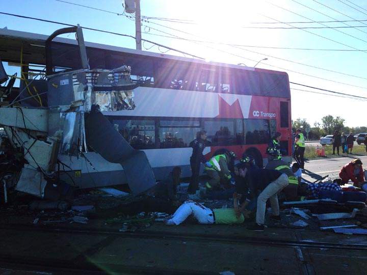 People are helped following a Via Rail train and a city bus collision in Ottawa’s west. (The Canadian Press /Terry Pedwell)
