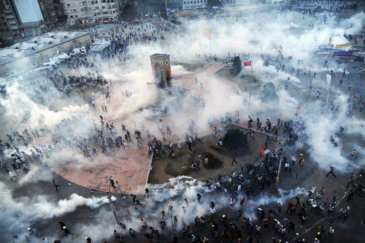 Turkish riot policemen fire tear gas on Taksim Square. (Bulent Kilic/AFP/Getty Images)