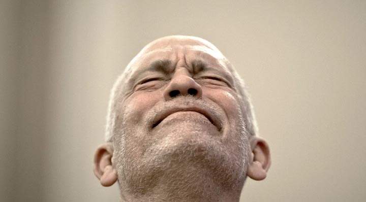 John Malkovich grimaces during a press conference in Bucharest, Romania. (AP Photo/Vadim Ghirda)