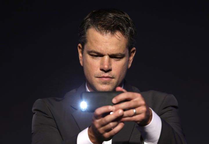 Matt Damon uses his mobile phone camera to take pictures during a press conference of his new film “Elysium” in Seoul, South Korea. (AP Photo/Lee Jin-man)
