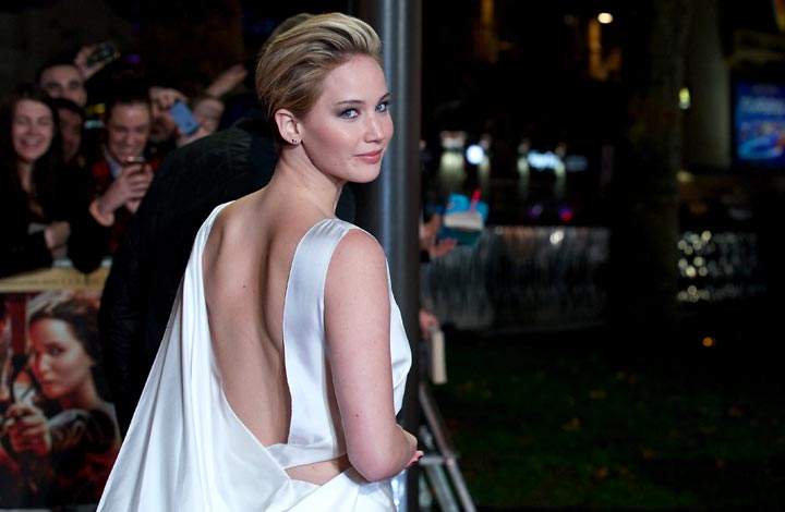 Jennifer Lawrence poses for pictures on the red carpet upon arrival for the world premiere of the film “The Hunger Games: Catching Fire” in London. (Andrew Cowie/AFP/Getty Images)