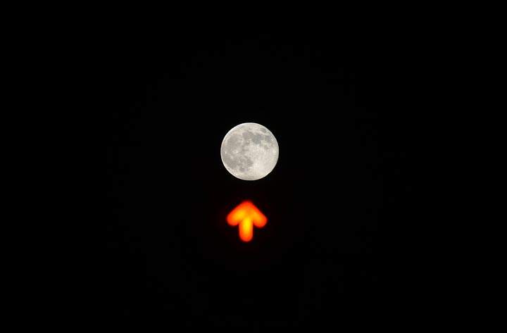 The supermoon is seen over a traffic light in downtown Rome. (Filippo Monteforte/AFP/Getty Images)