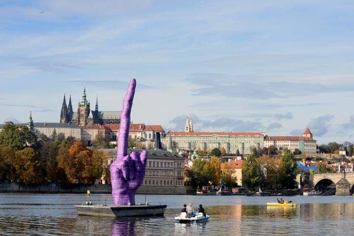 People sailing on boats on Vltava River look at a giant purple finger sculpture by Czech artist David Cerny in Prague. (Michal Cizek/AFP/Getty Images)