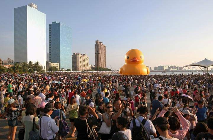 Local residents gather to see Dutch artist Florentijn Hofman’s yellow rubber duck at a harbour in the southern city of Kaohsiung. (Stringer/AFP/Getty Images)