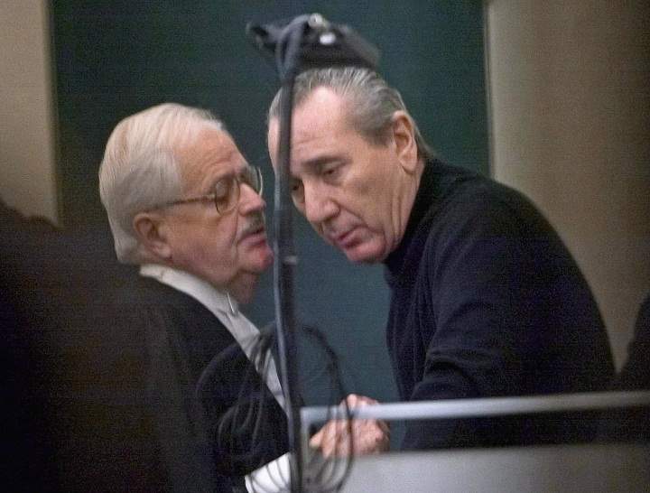 Vito Rizzuto, right, reputed head of the Montreal Mafia, speaks with his attorney Jean Salois after his hearing in Montreal on Feb. 6, 2004.