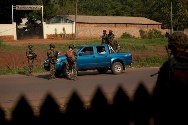 French troops stop a government minister's car carrying Seleka soldiers, at a checkpoint in Bangui, Central African Republic, Monday, Dec. 23, 2013. 