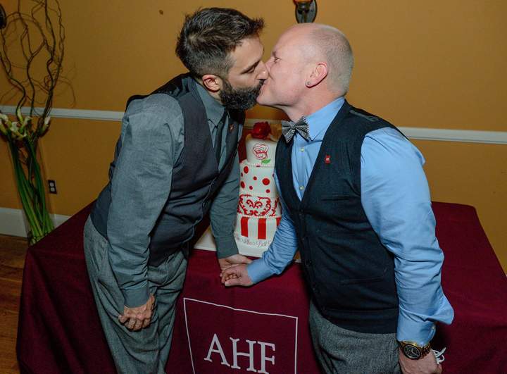 Danny Leclair and Aubrey Loots share a moment by their cake ahead of their wedding on the AIDS Healthcare Foundation's third annual float entry, "Living the Dream," for the 125th Tournament of Roses Parade in Pasadena, Calif.