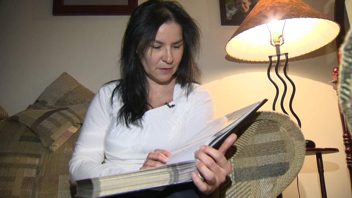 Jacqueline Sanderson flips through photos of her daughter, who was murdered last year.