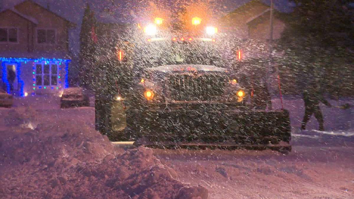 A snow plow drives through snowy Calgary during a blizzard on Tuesday, Dec. 3rd, 2013.
