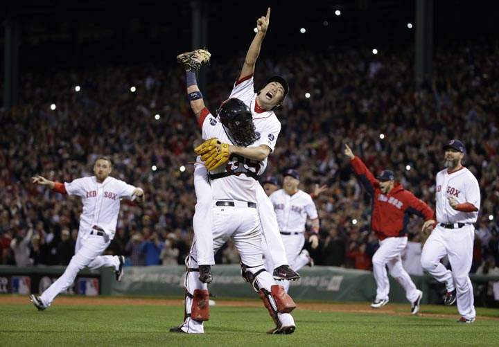 Boston Red Sox relief pitcher Koji Uehara, rear, and catcher Jarrod Saltalamacchia celebrate the Red Sox 5-2 win over the Detroit Tigers in Game 6 of the American League baseball championship series on Saturday, Oct. 19, 2013, in Boston. (AP Photo/Matt Slocum, File)