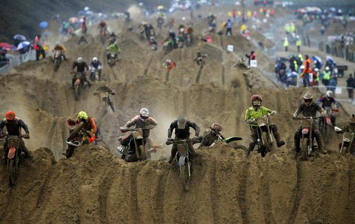 Riders reach the crest of a dune during the opening lap of the 2013 RHL Weston beach race in Weston-Super-Mare, southwest England, on October 13, 2013. (Adrian Dennis/AFP/Getty Images)