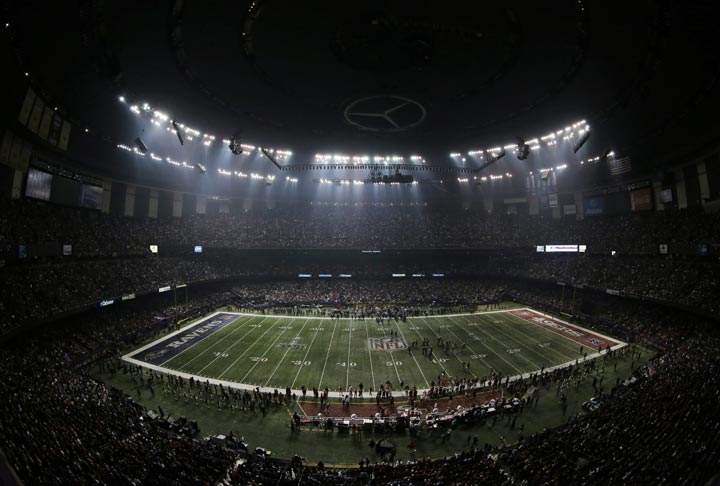 Fans and members of the Baltimore Ravens and San Francisco 49ers wait for power to return in the Superdome during an outage in the second half of Super Bowl XLVII on Sunday, Feb. 3, 2013, in New Orleans. (AP Photo/Charlie Riedel)
