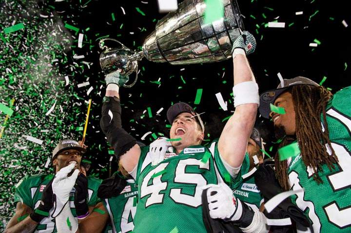 : Saskatchewan Roughriders linebacker Mike McCullough, defensive back Dwight Anderson and Dwight Anderson celebrate after the 101st CFL Grey Cup 2013 in Regina on November 24, 2013. (Matt Smith / The Canadian Press)