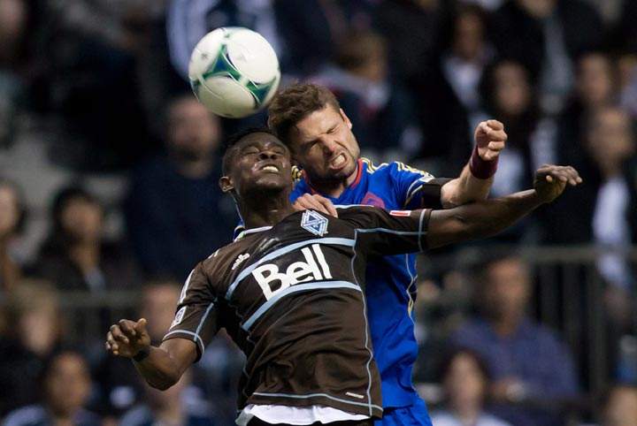 Vancouver Whitecaps’ Gershon Koffie, left , and Colorado Rapids’ Drew Moor vie for the ball during first half of MLS soccer action in Vancouver, B.C., on Sunday October 27, 2013. Darryl Dyck / The Canadian Press)