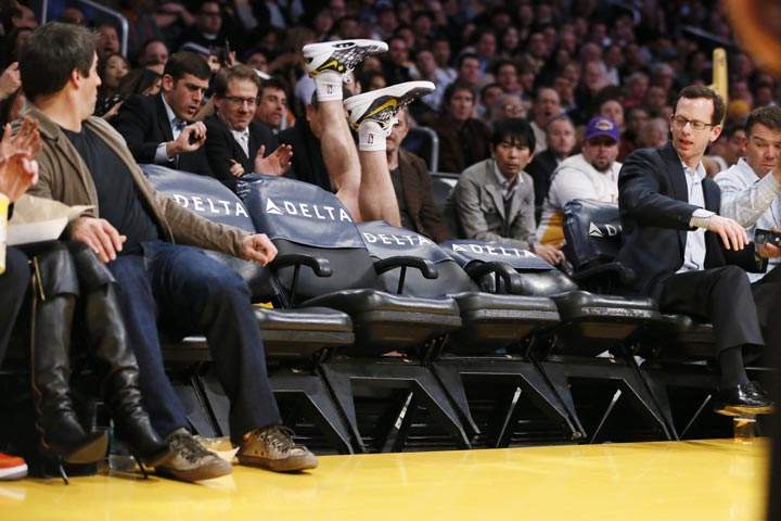 Los Angeles Lakers’ Steve Blake falls over empty courtside chairs as he tries to save a ball from going out of bounds against the Phoenix Suns during the first half of an NBA basketball game on Tuesday, Feb. 12, 2013, in Los Angeles. (AP Photo/Danny Moloshok)