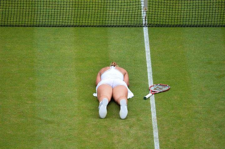 Sabine Lisicki celebrates on the floor after beating Serena Williams during the fourth round women’s singles match on Day 7 of the 2013 Wimbledon Championships tennis tournament at the All England Club in Wimbledon on July 1, 2013. (Ben Stansall/AFP/Getty Images)