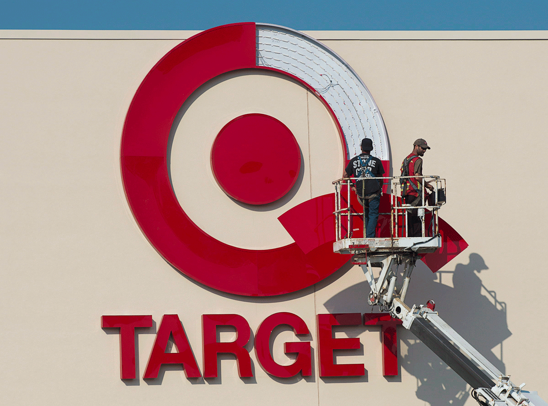 Workers install an outdoor sign at the new Target store at the Mic Mac Mall in Dartmouth, N.S., on July 20, 2013.