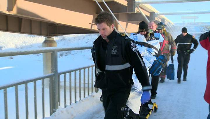 A woman is taken to hospital by paramedics after the vehicle she was driving went over the Circle Drive North Bridge and into the South Saskatchewan River.