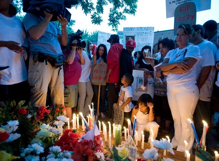 Lilian Villanueva, mother of Fredy Villanueva, attends a vigil at at the site where her son was killed on the first anniversary of his death in Montreal, Sunday, August 9, 2009. A