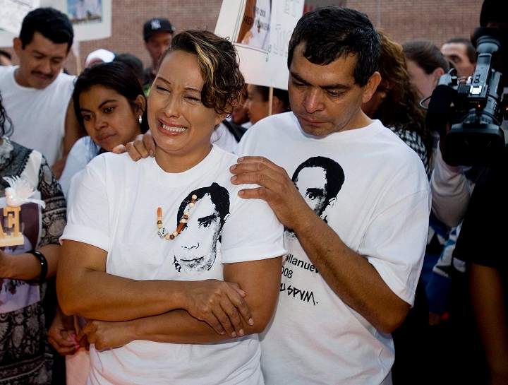 Gilberto and Lilian Villanueva, parents of Fredy Villanueva, attend a vigil at at the site where their son was killed on the first anniversary of his death in Montreal, Sunday, August 9, 2009.