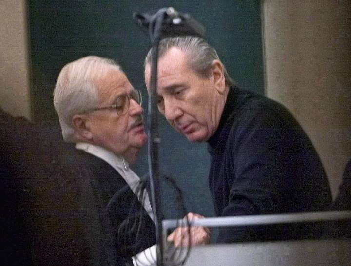 Vito Rizzuto, right, reputed head of the Montreal Mafia, speaks with his attorney Jean Salois after his hearing in Montreal on Feb. 6, 2004.
